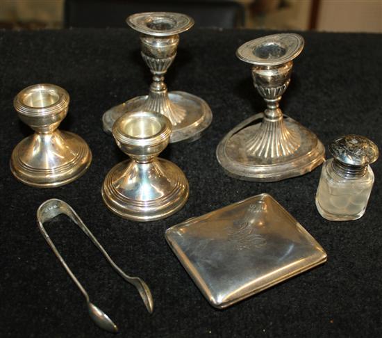 A silver cigarette case, 2 pairs of candlesticks, silver mount scent bottle & pair of silver sugar nips (6)